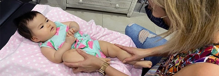 Chiropractor Houston TX Veronica Claudia Kusnir Examining Infant Patient